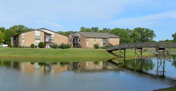A bridge over a body of water with buildings in the background.